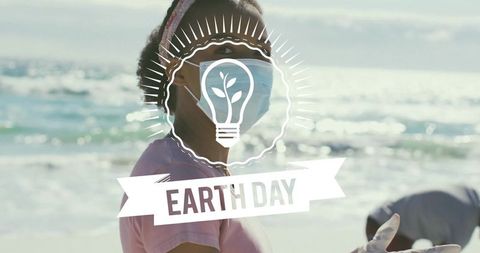 Volunteer cleaning beach wearing mask and gloves during earth day coastal cleanup