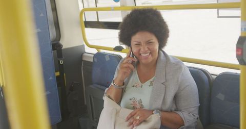 Smiling Biracial Woman Chatting on a Bus, Embracing Mobility