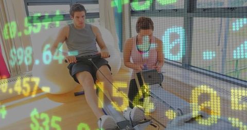 Personal Trainer Monitoring Client on Rowing Session in Modern Gym