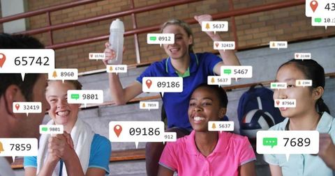 Youth volleyball team reacting to live social engagement overlays on school bleachers