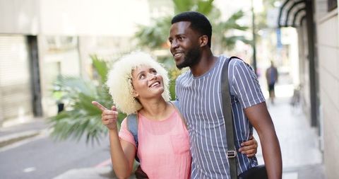 Diverse Couple Enjoys Relaxed City Stroll on Vacation