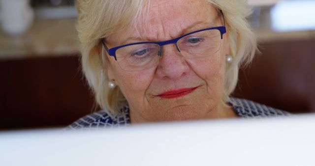 Senior Woman Focused on Computer Screen, Technology for Elderly - Download Free Stock Images Pikwizard.com