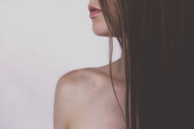 Close-up of woman with long straight hair and bare shoulders - Download Free Stock Photos Pikwizard.com