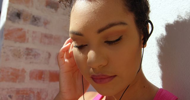 Woman Listening to Music with Earphones on Sunny Day - Download Free Stock Images Pikwizard.com