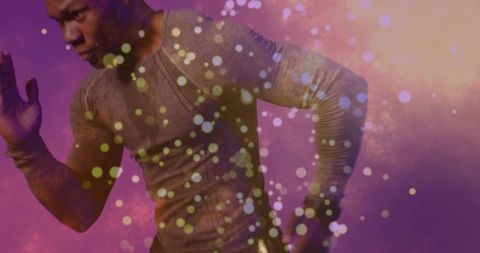 Male athlete lunging amid vibrant colorful particles