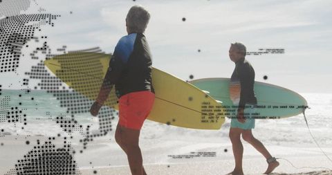 Senior couple with surfboards embracing active adventure upon beach