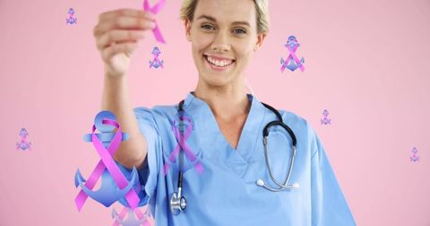 Smiling female doctor promoting breast cancer awareness with ribbons