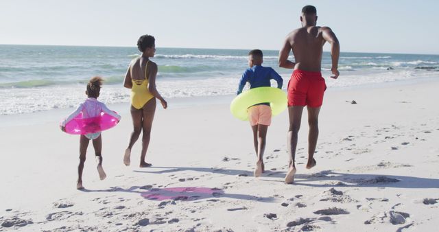 Family enjoying day at beach with inflatable swim rings - Download Free Stock Images Pikwizard.com