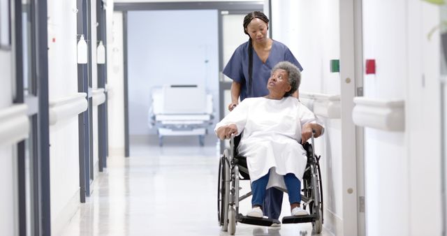 Nurse is assisting senior patient in wheelchair through hospital hallway. Ideal for concepts related to healthcare, elderly care, medical assistance, patient care in clinics and hospitals, healthcare professionals providing support, and compassionate caregiving.