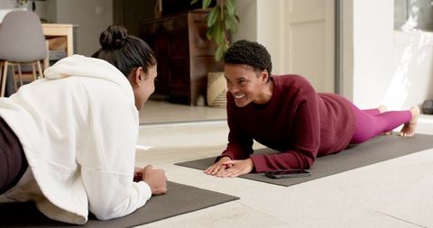 Diverse friends engaging in home workout with yoga mats