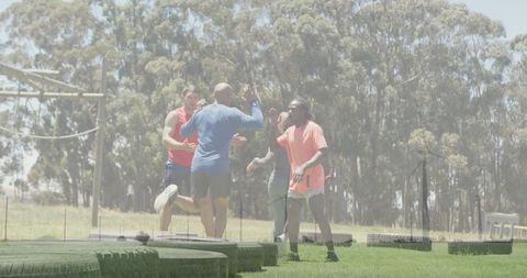Energetic Athletes Celebrating Success on Outdoor Training Field