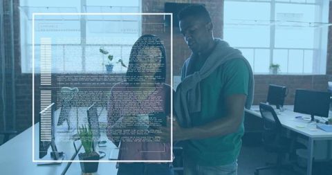 Team of software developers collaborating in modern open-plan office