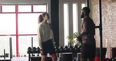 Couple Engaging in Fitness Training at Modern Gym