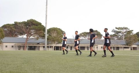 Young Soccer Players Practicing Teamwork and Fitness on Field