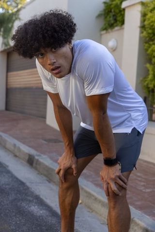 African american man pausing from outdoor fitness run