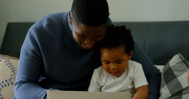 Father and Son Bonding Over Laptop on Couch - Download Free Stock Images Pikwizard.com