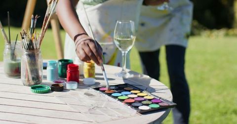 African American Woman Enjoying Artistic Outdoor Painting Activity