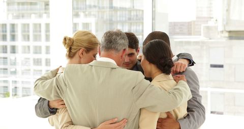 Business Team Embracing Positivity in a Team Huddle