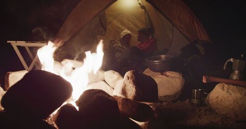 Couple Enjoying Campfire Near Tent Embracing Tranquility - Download Free Stock Images Pikwizard.com