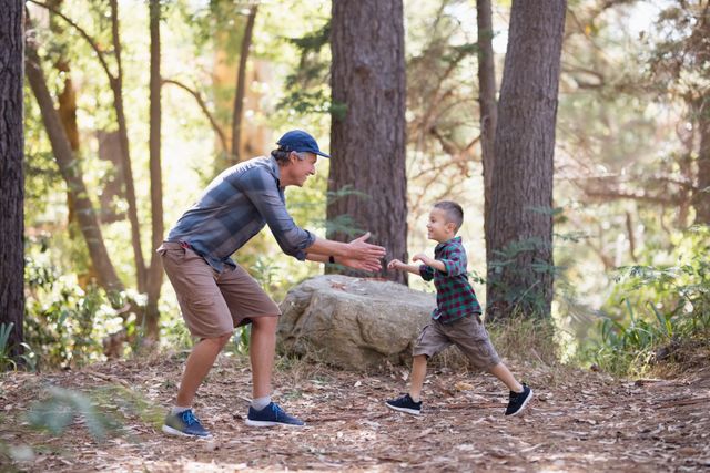 Father and son playing while hiking in forest