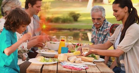 Family Enjoying Outdoor Meal Together in Lush Park Ambiance - Download Free Stock Images Pikwizard.com