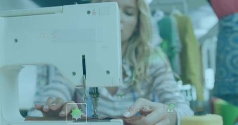 Female seamstress sewing brown fabric on white sewing machine in bright workshop, close-up
