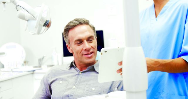 Male Patient Consulting with Dentist in Dental Clinic - Download Free Stock Images Pikwizard.com