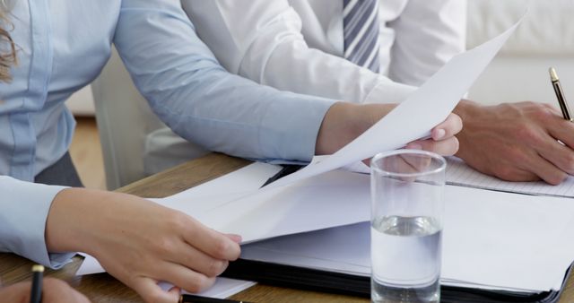 Business team reviewing documents during meeting - Download Free Stock Images Pikwizard.com