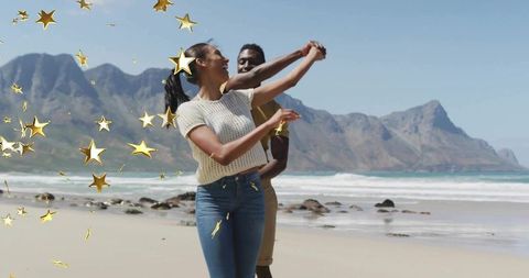 Joyful Couple Dancing on Scenic Beach with Golden Confetti