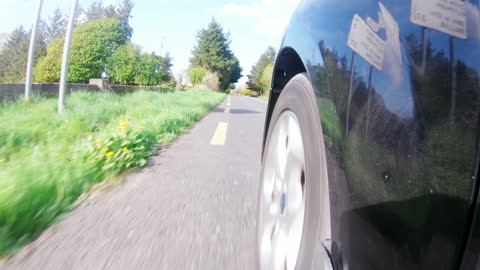 Car Driving Fast on Scenic Country Road in Daylight