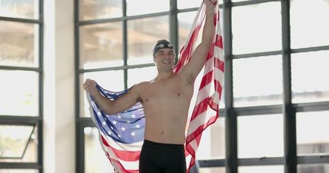 Triumphant Swimmer Holding US Flag in Victory Pose
