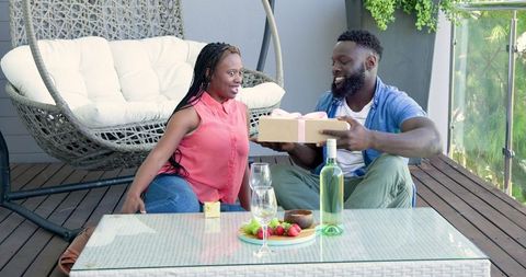 Romantic Outdoor Picnic on Patio with Wine and Gift Exchange