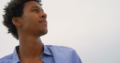 Confident Man in Blue Shirt Gazing Into Distance - Download Free Stock Images Pikwizard.com