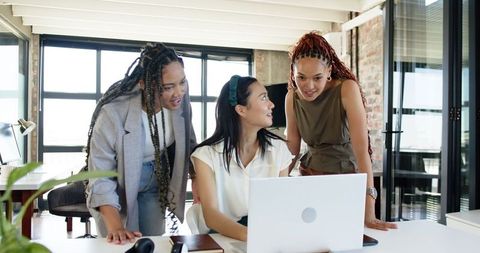 Diverse Team of Women Collaborating on Business Project in Modern Office