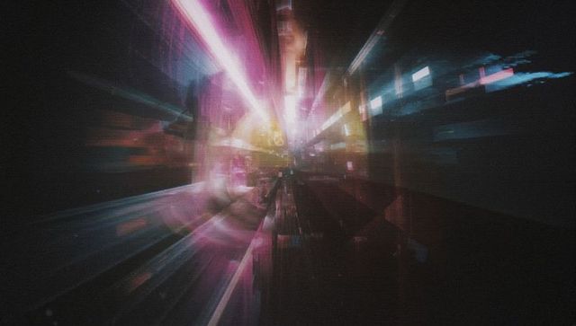 Vibrant Neon Streaks Illuminate Nighttime Cityscape