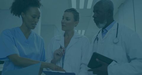 Medical professionals discussing patient information in corridor