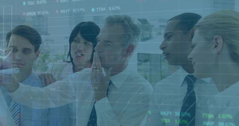 Executive team collaborating at glass board with financial charts, stock tickers