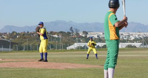 Pitcher Preparing Throw While Batter Awaiting Swing on Suburban Baseball Diamond