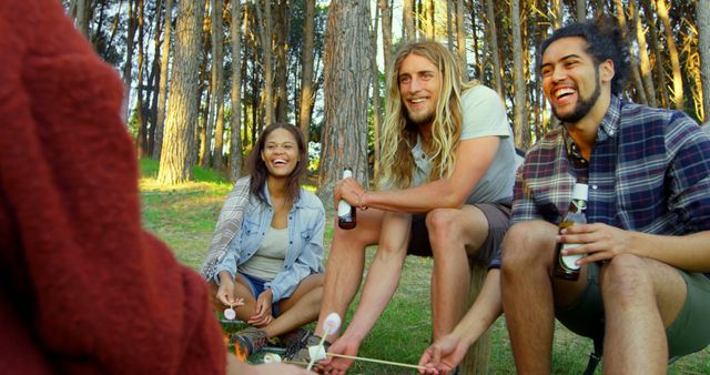 Friends Enjoying Campfire with Marshmallows and Drinks in Forest - Download Free Stock Images Pikwizard.com