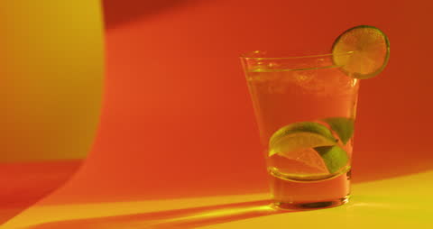 Refreshing Lime Cocktail with Orange Background