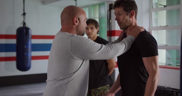 Self-defense training in gym with mixed-aged men practicing techniques - Download Free Stock Images Pikwizard.com