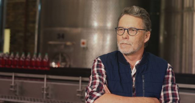 Senior Craftsman Poses in Winery with Industrial Equipment - Download Free Stock Images Pikwizard.com