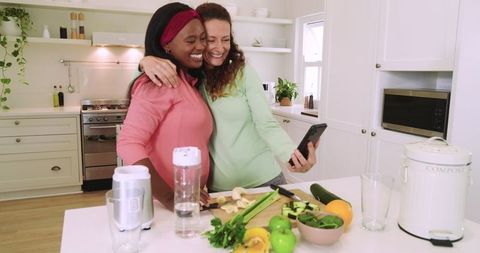 Friends Hugging and Taking Selfie in Scandi Kitchen with Fresh Produce