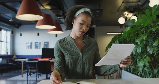 Female Professional Reviewing Documents in Modern Office Space - Download Free Stock Images Pikwizard.com