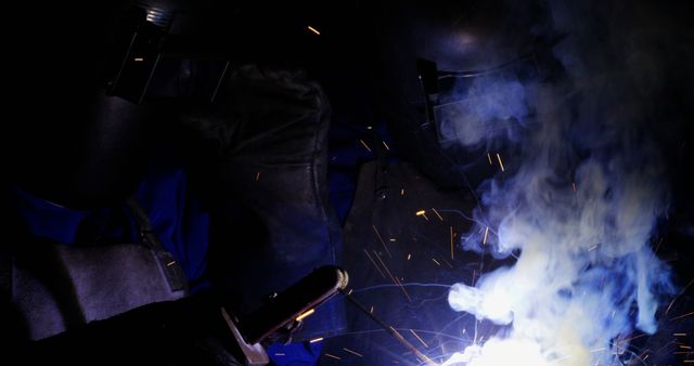 Welding Process with Sparks and Smoke in Dark Workshop - Download Free Stock Images Pikwizard.com