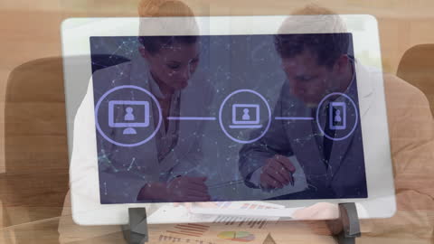 Business Professionals Analyzing Digital Network on Tablet