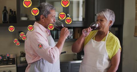 Senior Couple Enjoying Wine with Social Media Hearts Effect