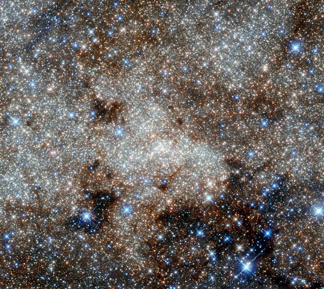 This intricate observation captures the red center of the Milky Way galaxy, showcasing the densely packed stars illuminated in infrared light. The area towards the Sagittarius constellation reveals numerous complex objects often cloaked in optical wavelengths but visible here. Despite these brilliant views, the supermassive black hole Sagittarius A*, hidden in the center, remains elusive. Useful for educational materials on astronomy, or as breathtaking cosmic imagery in science publications, presentations, and websites exploring galactic structures and infrared astronomy.