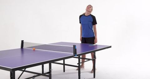 Woman resting after table tennis play in minimalist studio