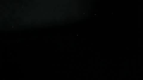 Breaking Tomato in Super Slow Motion Against Dark Background